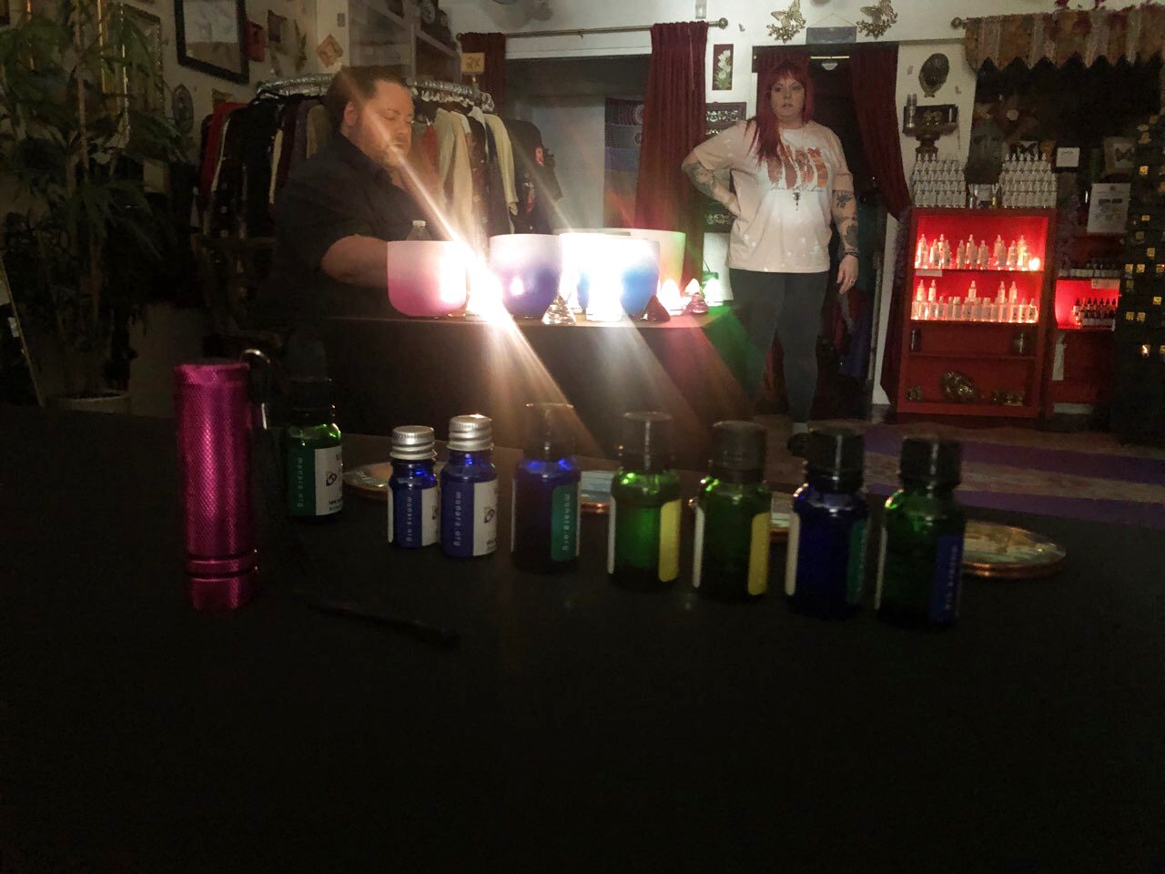 Essential oils and crystal singing bowls at a Prismatic Flower Essences sound healing session